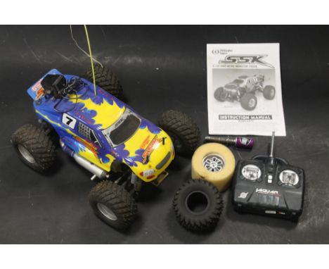 A THUNDER TIGER SSK 1/10 4WD NITRO MONSTER TRUCK WITH CONTROLLER AND INSTRUCTION MANUAL 