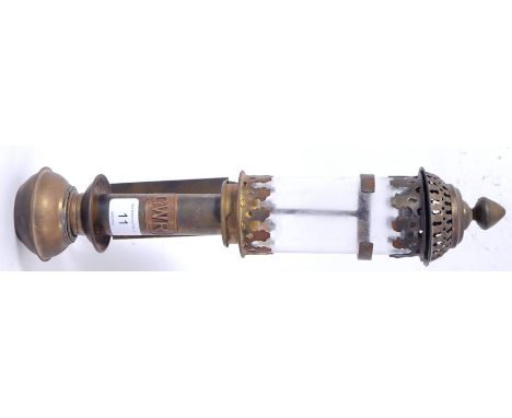 A 20th century GWR brass carriage lamp. The glass shade with fret worked top and bottom raised on brass column base. Plaque m