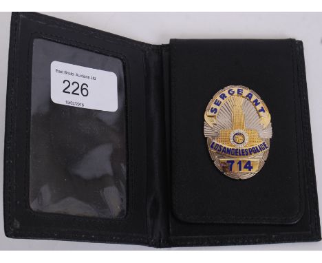 An original Los Angeles Police Dept. officers warrant / uniform badge. Sgt 714. Within the original warrant leather case. Thi