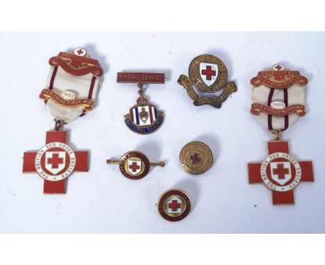 A collection of enamel set British Red Cross Society medals - Proficiency in Red Cross First Aid. Two with ribbons and three 