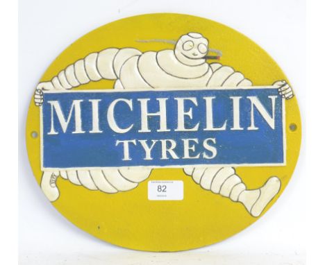 MICHELIN MAN: A vintage style reproduction Michelin Man metal sign, depicting the early style Bibendum mascot smoking. 30cm l