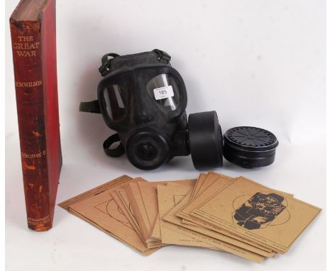 MILITARIA: A collection of assorted militaria to include a vintage gas mask, unused paper rifle targets (several designs) and