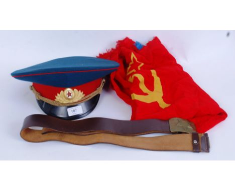 RUSSIAN MILITARY: An original vintage Russian military peaked cap, along with a uniform leather belt and buckle and a flag. 