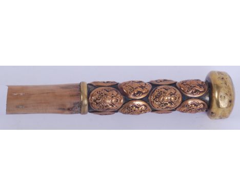 A World War One Sargeants swagger stick. Tapering wooden stem with brass applied general service corps buttons to the handle