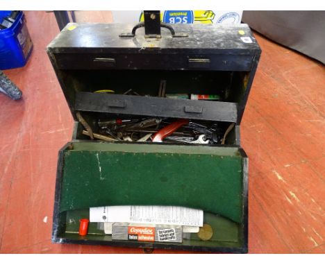 Black wooden toolbox with initials 'K N B' with contents