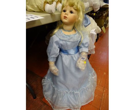 Doll with long light blue silk dress and blonde hair