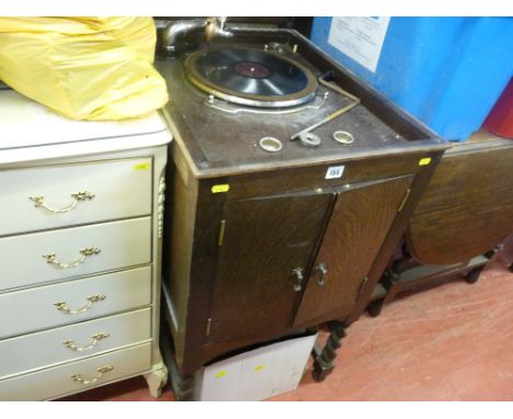 Vintage record player in wooden case with integral speaker and a quantity of records