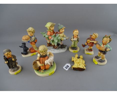 Seven Goebel/Hummel figurines and a composite figure of two Japanese ladies