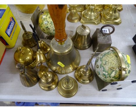 Collection of brass bells, pair of globe bookends and a vintage brass weight