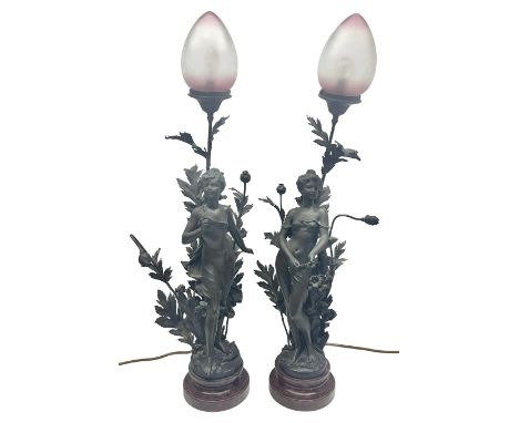 Pair of Art Nouveau style spelter figural table lamps, each mounted on rouge marble effect circular bases, with toleware flow