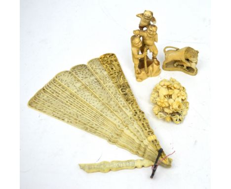 A finely carved ivory fan (af), a small ivory figure group depicting a lion and his catch, a further carved ivory figure grou