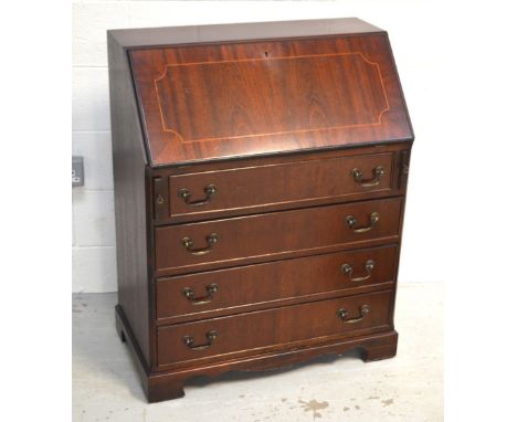 A reproduction four-drawer mahogany bureau on bracket feet, width 75cm.