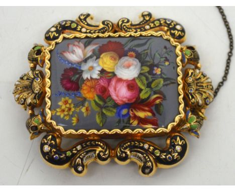 A Victorian gold and enamel mourning brooch, the central rectangular enamel panel decorated with roses, lilies and carnations