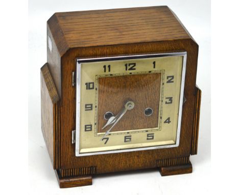 A c1930 Art Deco oak-cased eight-day mantel clock, silvered dial set with Arabic numerals.