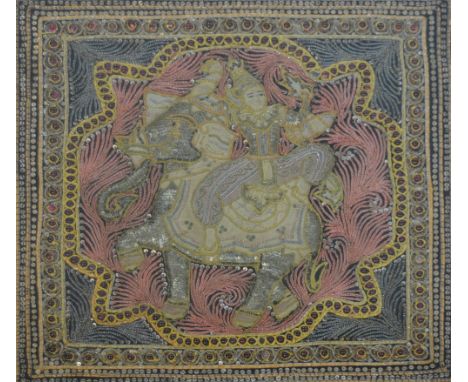 A 20th century Thai woven 'jewel'-adorned and raised panel depicting a figure upon an elephant, approx 49 x 49cm, framed and 