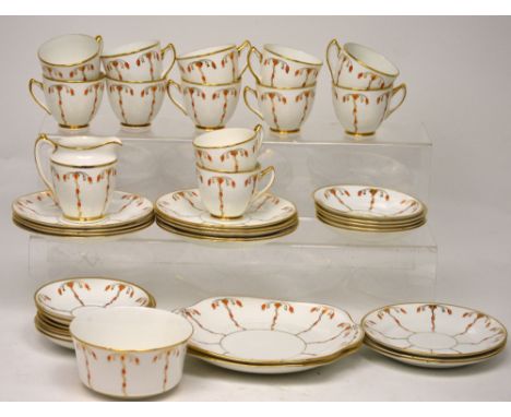 A c1930s Art Deco part tea service 'Orange Tree', comprising sandwich plates, side plates, cups, saucers, sugar bowl and milk
