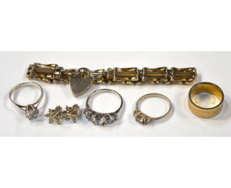 Three silver dress rings, all set with white stones, a yellow and white metal engraved band, a white metal gate bracelet, a p