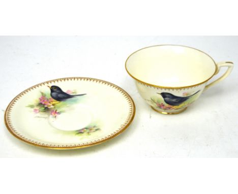 Royal Worcester; a cup and saucer painted with blackbird amongst flowers by Edward Townsend, black printed marks.   CONDITION