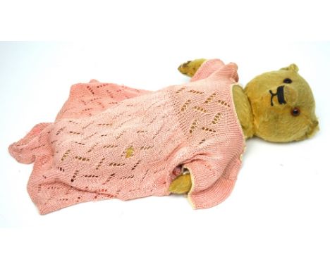An early-to-mid 20th century Chad Valley straw-filled teddy bear with darned paws, length approx 37cm.