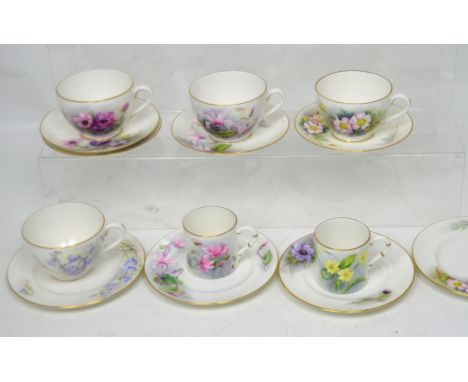 Royal Worcester; four porcelain trios decorated with flowers by D Rea, also two coffee cans (14).