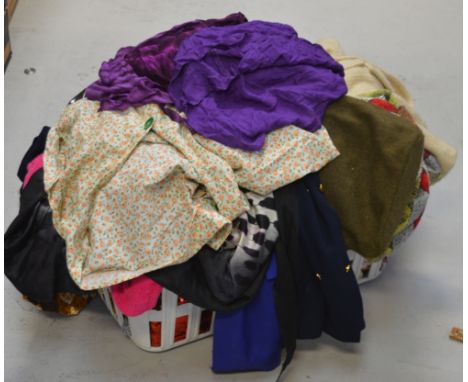 A quantity of vintage clothing and linen to include jackets, jumpers, a vintage throw, curtains etc.