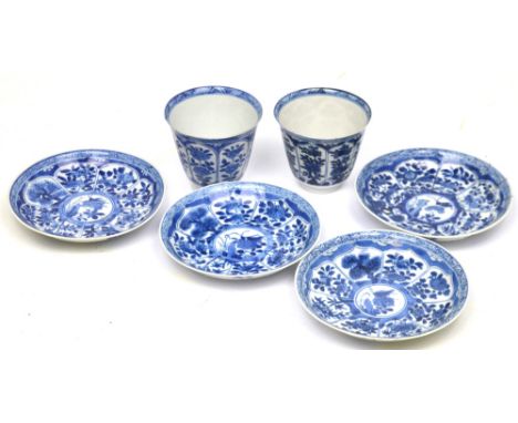 A pair of early 19th century blue and white tea bowls decorated with bands of floral decoration with abstract blue rim, blue 