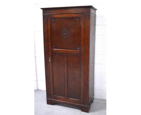 A single door 'Magnum' oak wardrobe with fitted interior, raised on bracket feet, width 94cm.