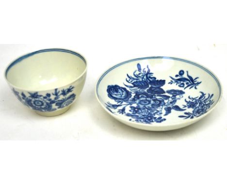 Worcester; a c1770 blue and white printed tea bowl and saucers, Three Flower pattern, blue crescent mark with hatching to the