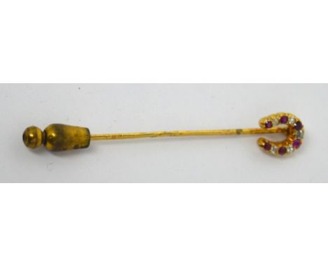 A 14ct gold stick pin mounted with a horseshoe setting of diamonds and rubies.