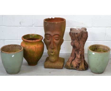 A terracotta garden planter in the form of a head, a pair of duck egg blue ceramic pots, a terracotta ovoid pot and a garden 