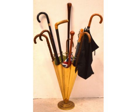 A brass umbrella stand in the form of an umbrella, containing a vintage silk umbrella with bamboo handle and a collection of 