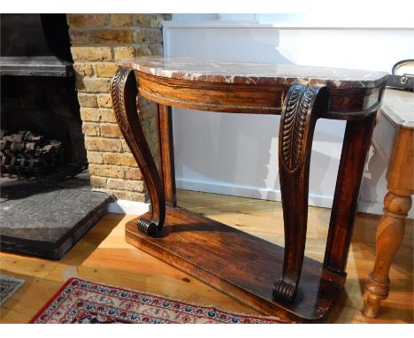 A Regency rosewood console table with a red marble top and gilt metal mounts; 105 cm wide; 87 cm high; signs of wear to base.