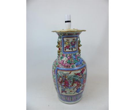 A large Chinese vase, painted in the famille rose palette, decorated with pictorial reserves depicting battle and court scene