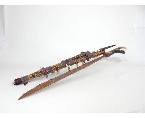 A Polychromed Dayak Mandau Sword decorated with beads, human hair and animal teeth, from either Malaysian or Indonesian Borne