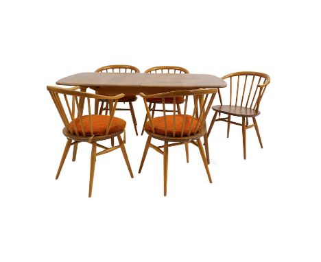 An Ercol elm and beechwood dining table 88cm wide71cm high150cm longtogether with an Ercol elm sideboard, Windsor design, hav