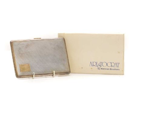A silver cigarette case, by Harman Brothers, Birmingham 1977, with engine turned decoration and date engraving to interior,14