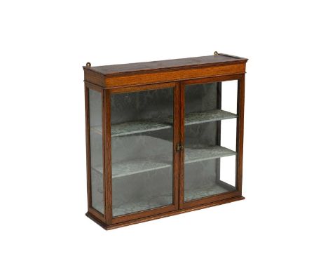 An oak hanging display cabinet early 20th centurythe moulded cornice above pair of glazed panel doors69cm wide20cm deep66cm h