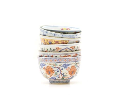 A collection of Chinese and Japanese blue and white porcelain bowls, 18th-19th century, later painted with figures, birds and