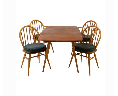 An Ercol elm and beech Windsor dining suite c.1950, comprising a drop leaf table, two side chairs, and two elbow chairs, chai