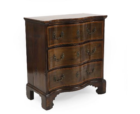 A serpentine mahogany, satinwood and oak chest of drawers, in the Georgian taste, with three drawers on bracket feet, 73.5cm 