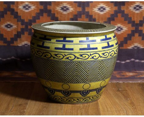 A Chinese blue and yellow fish bowl, c.1920, bands of scroll and geometric decoration,47cm diameter40cm high