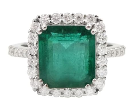 18ct white gold emerald and round brilliant cut diamond cluster ring, with diamond set shoulders, stamped 18K, emerald approx