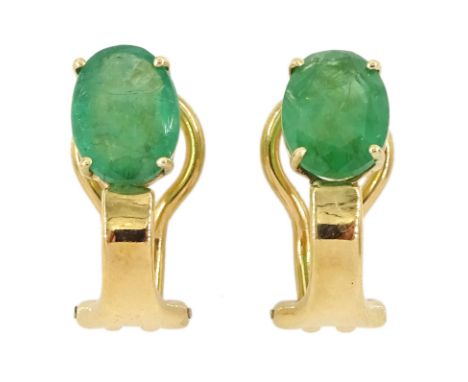 Pair of 18ct gold single stone oval cut emerald clip-on earringsCondition Report:Approx 3.55gm, tested 18ct, length = 17mm