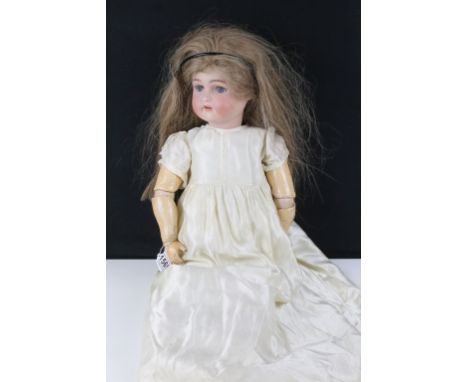 Kämmer &amp; Reinhardt German bisque composite doll having a bisque head with hand painted details, open mouth with four teet
