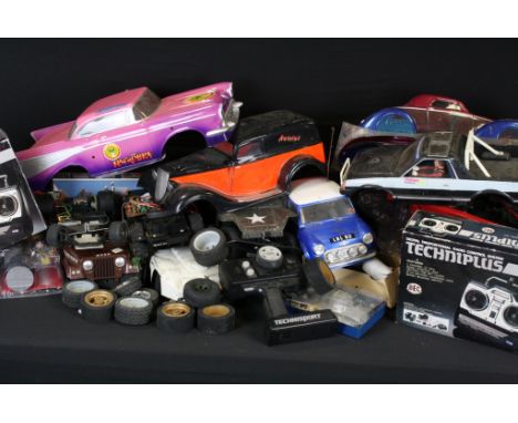 Collection of various remote control cars and accessories to include blue Mini Cooper, white body racing car, US Army Jeep ty