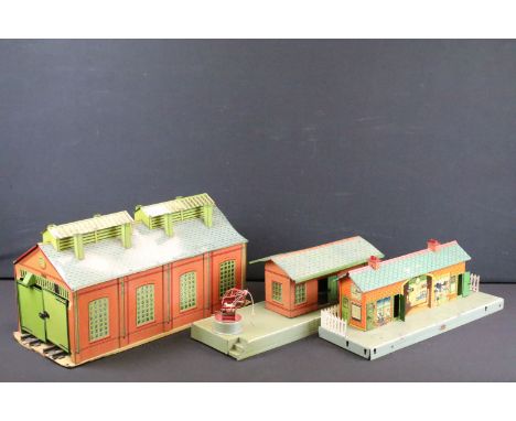 Three Hornby O gauge tin plate trackside buildings to include Station, 2 track engine shed and Crane/goods platform, some pai