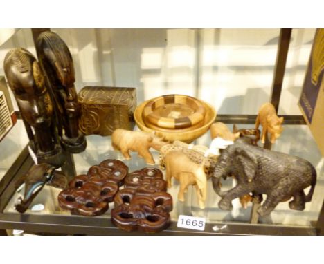 Shelf of carved items including tribal art