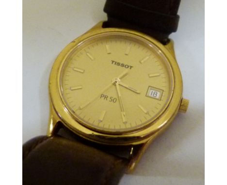Gents Tissot gold plated watch on a leather strap, working at lotting 