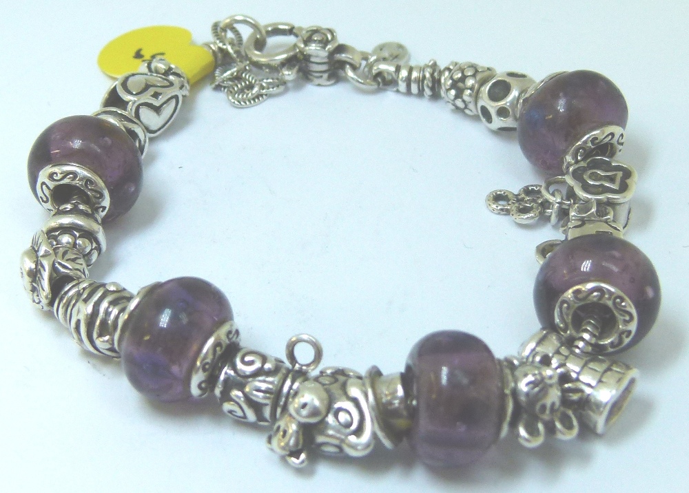 Sterling silver charm bracelet with assorted silver charms from Warren