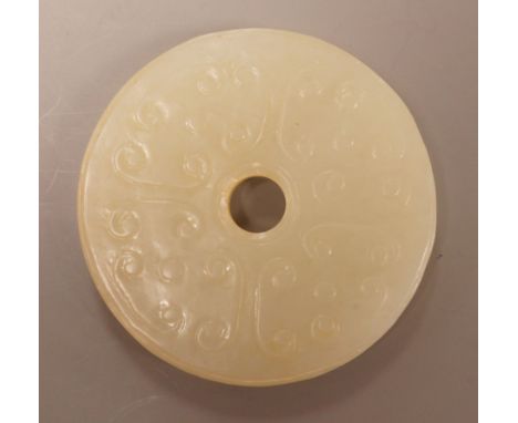 A Chinese pale celadon jade bi disc